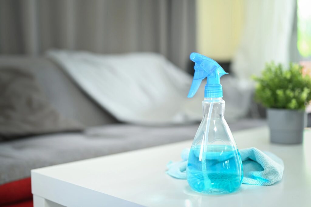Cleaning supplies placed on modern coffee table at home. Household cleaning concept